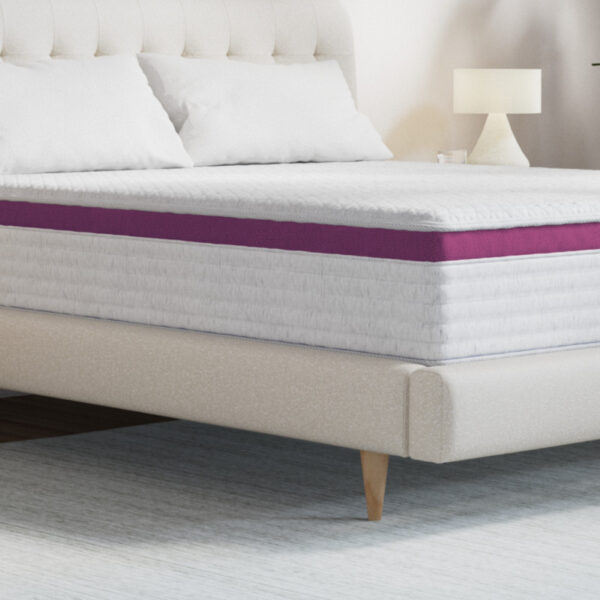 Comfortable queen bed with modern lamp and bedding.