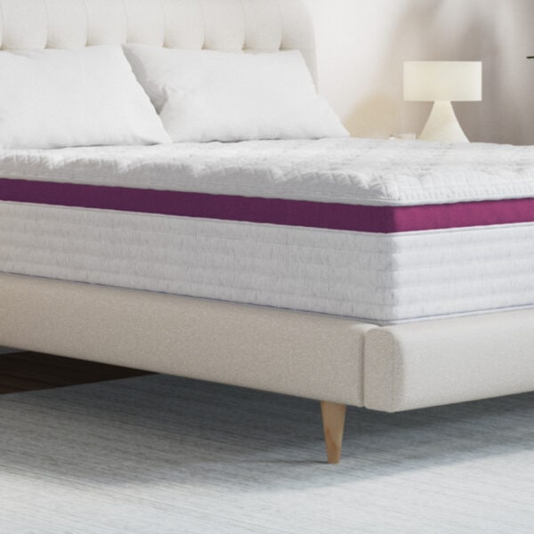 Comfortable bed with pillows and luxurious mattress