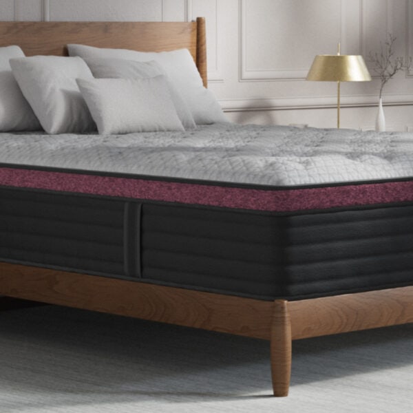 Luxurious bed with plush mattress and cushions.