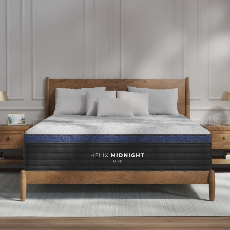 Elegant bedroom with modern mattress and wooden bed.