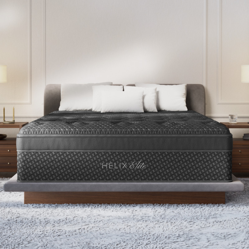 Luxurious king-size mattress with pillows in modern bedroom.