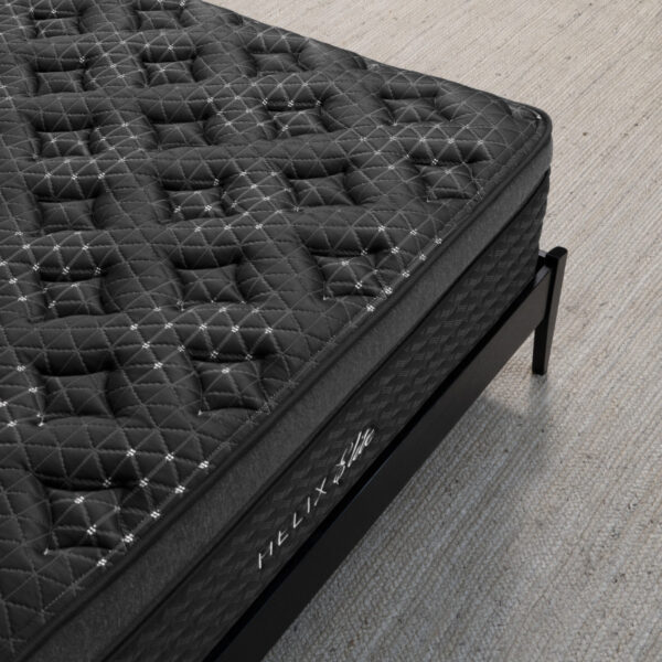 Black quilted mattress on metal frame bed