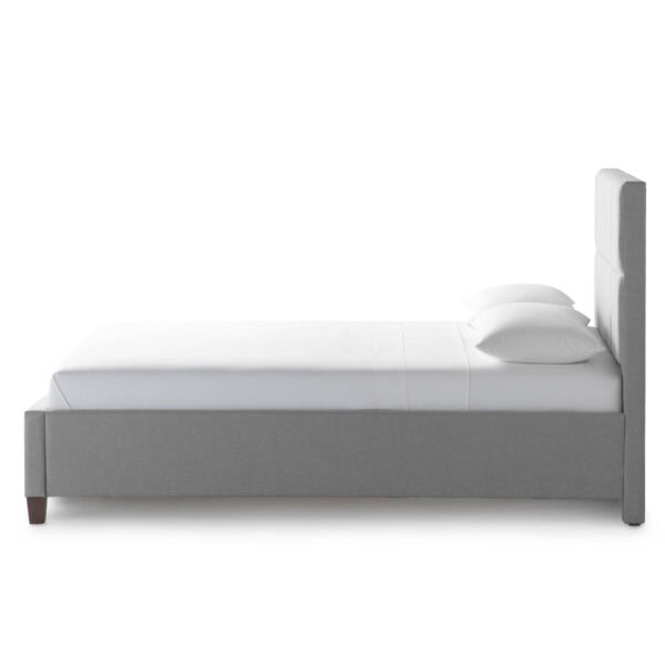 Modern gray bed with pillows and headboard