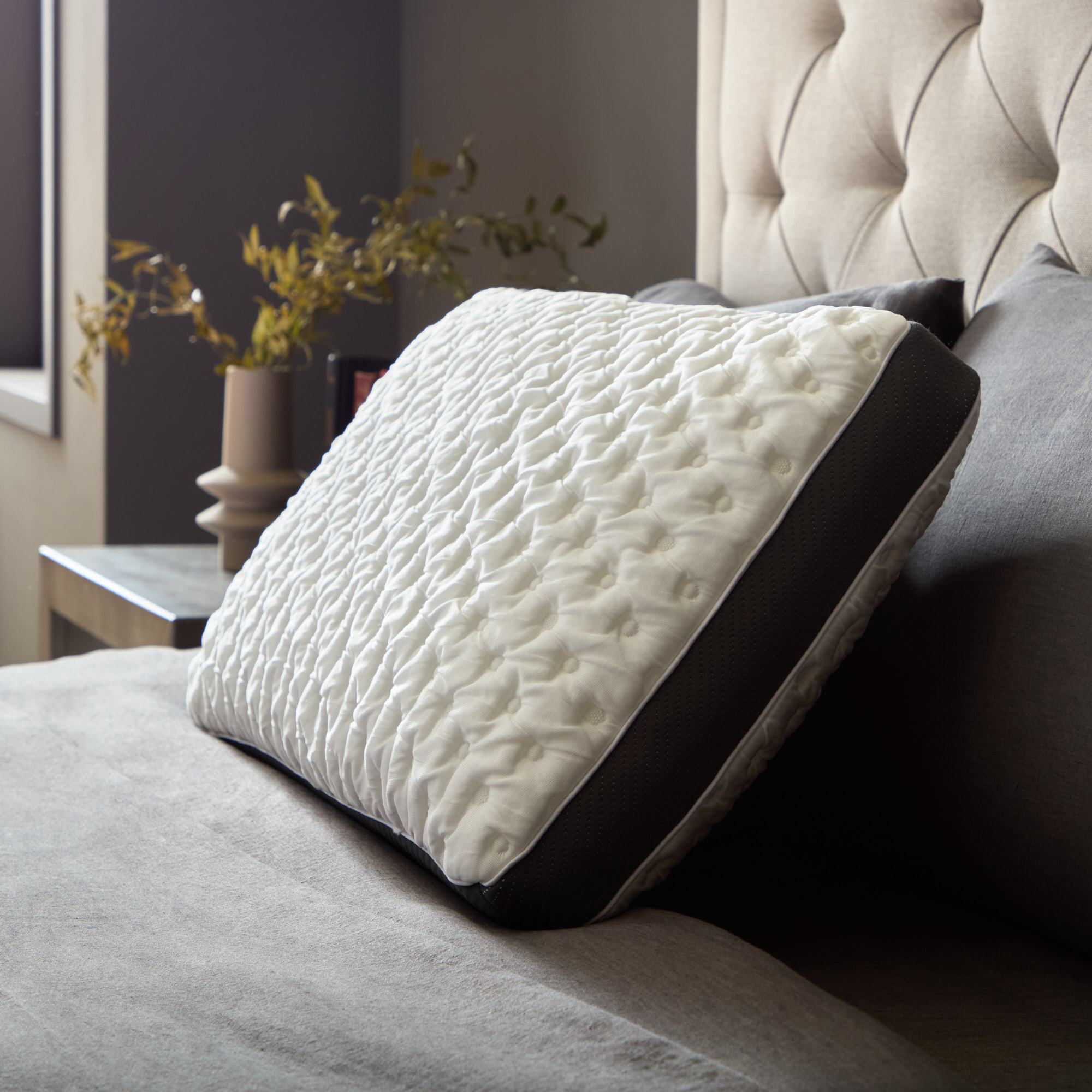 Elegant orthopedic pillow on a stylish bed
