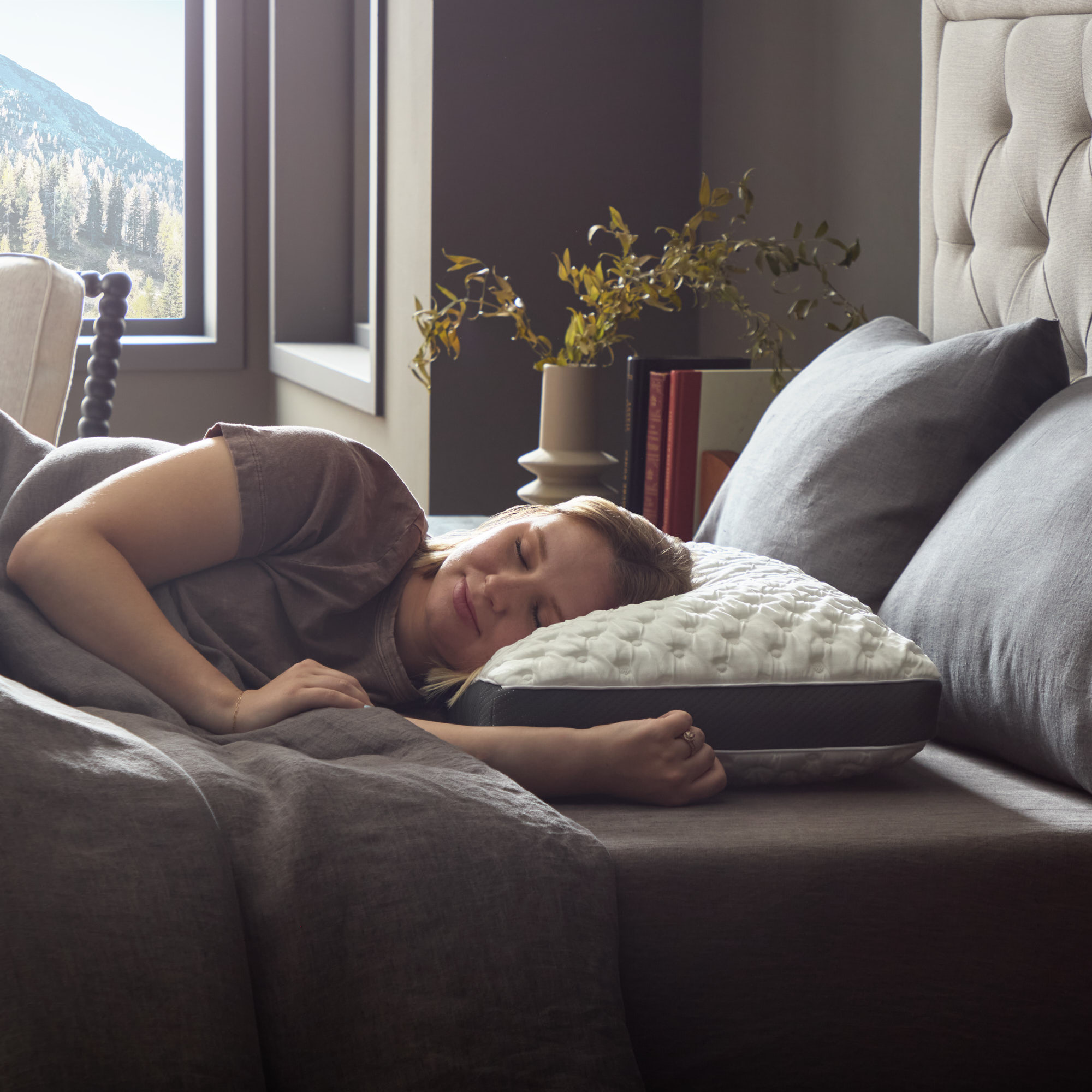 Woman peacefully sleeping on bed with pillow