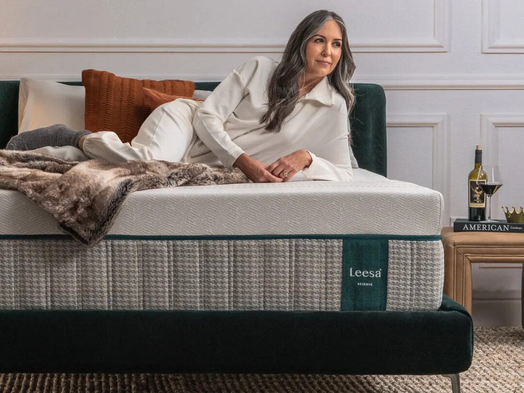 Woman relaxing on a Leesa mattress in bedroom.